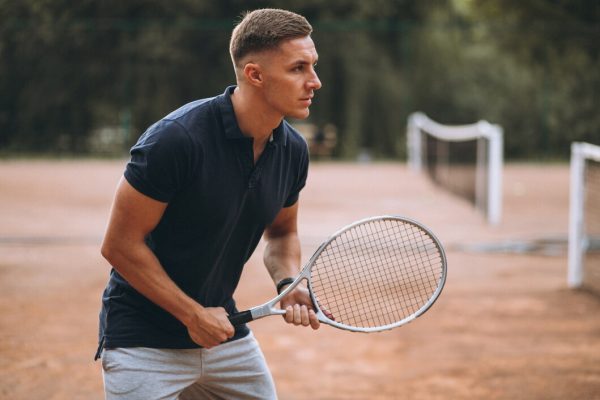young-man-playing-tennis-court_1303-15998
